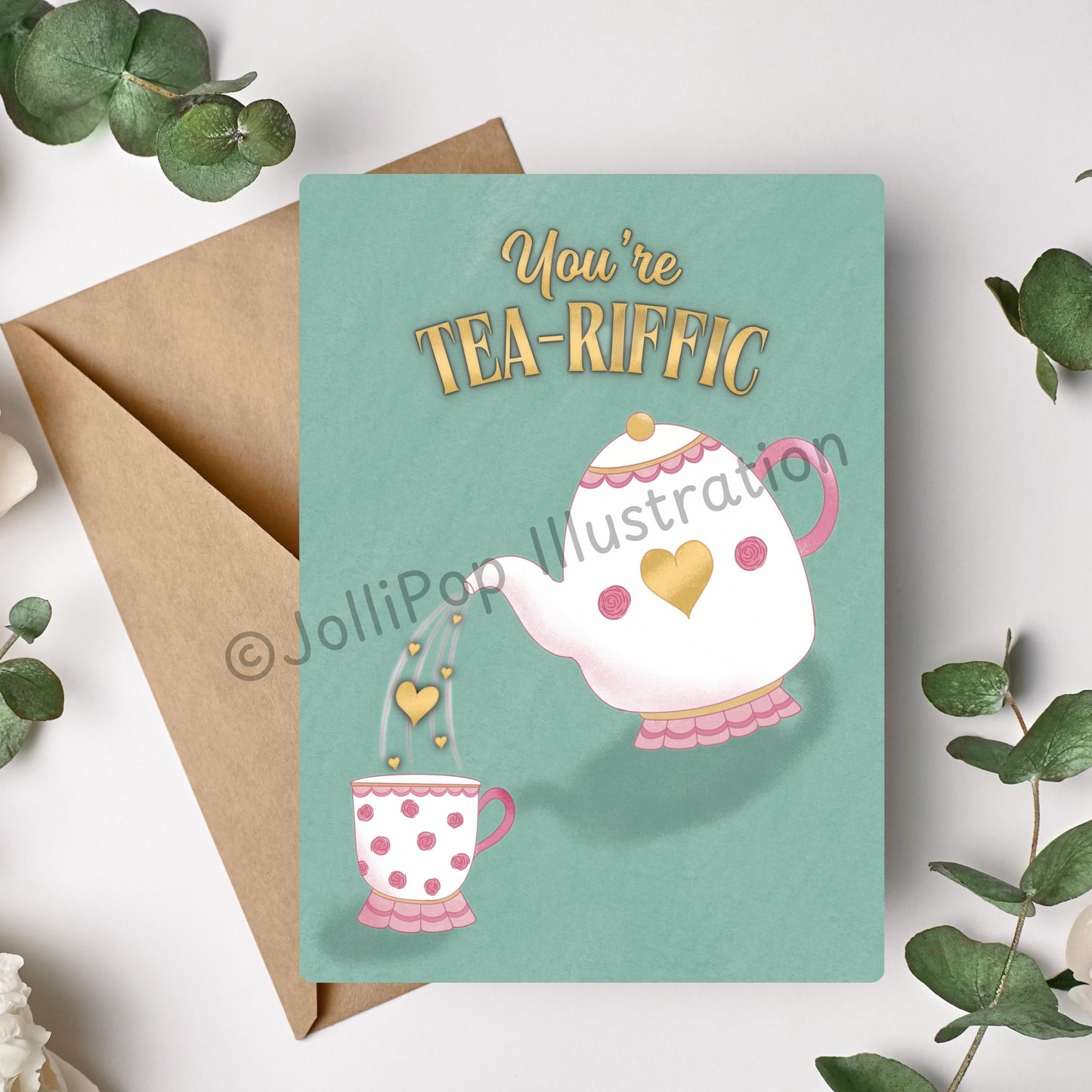Playful pun card for tea lovers – green card with elegant teapot and cup, floral details, and heart-shaped tea pour. Font reads "you're tea-riffic"